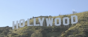 The image shows the famous Hollywood Sign situated on the hills of Los Angeles, California. The iconic white letters spell "HOLLYWOOD" and are positioned on the southern slope of Mount Lee in the Hollywood Hills area of the Santa Monica Mountains.